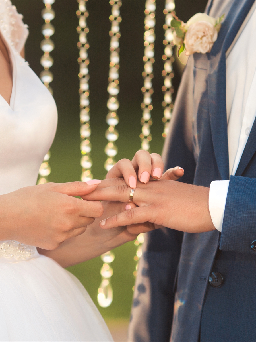 Novios tomados de la mano durante su boda al aire libre