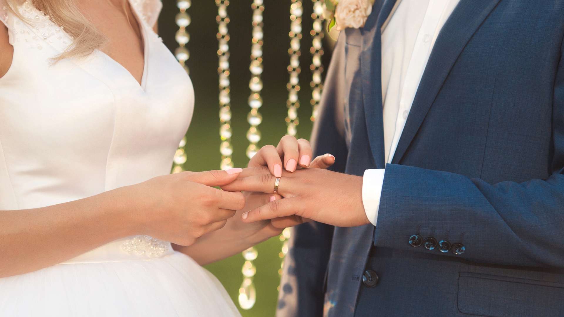 Novios tomados de la mano durante su boda al aire libre